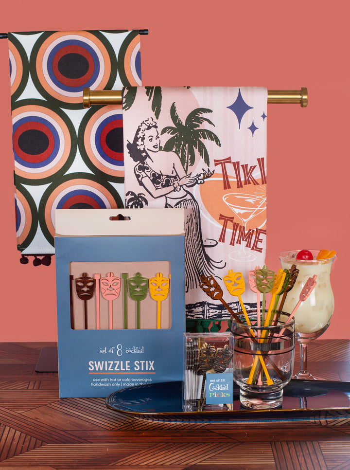 tiki time vintage hawaii bar towel with nostalgic chenille pom trim - shown with tiki mask acrylic beverage mixing swizzle sticks and tiki mask cocktail picks