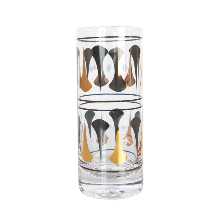 A tall highball cocktail glass with black and gold dart designs. mid century modern barware.
