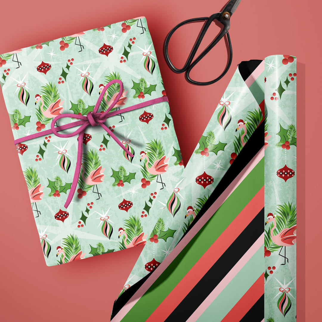 Double-sided 20x29-inch retro holiday gift wrap featuring whimsical pink flamingos, vintage Christmas ornaments, holly, and coordinating striped wrapping paper.