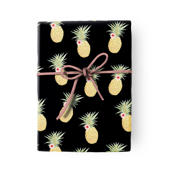 Black gift wrap with a repeating pineapple pattern