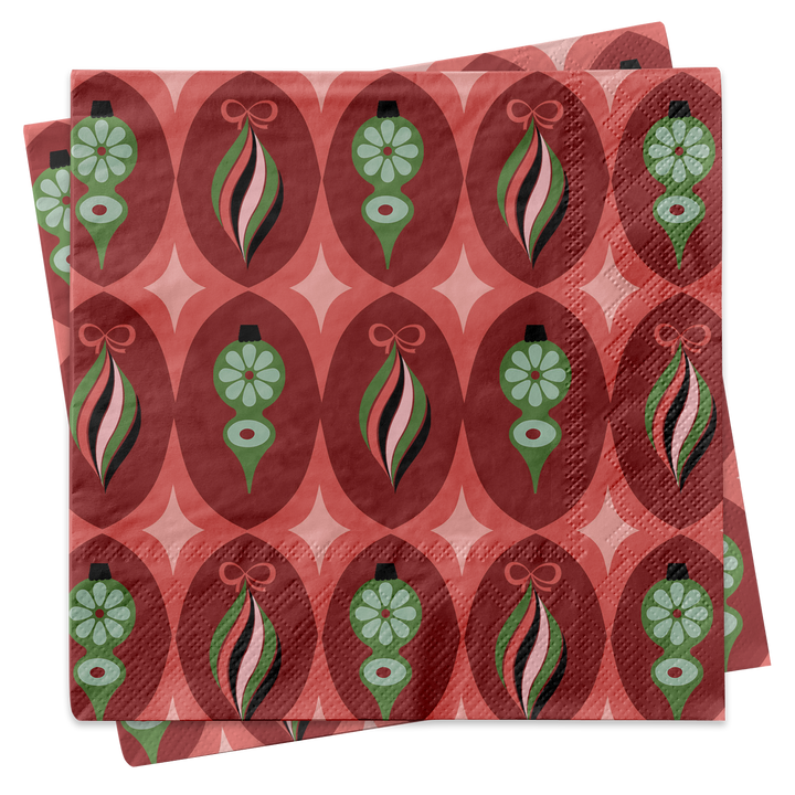 A stack of square paper napkins featuring a retro 1970s-style holiday ornament pattern in red, pink, green, and black on a white background.
