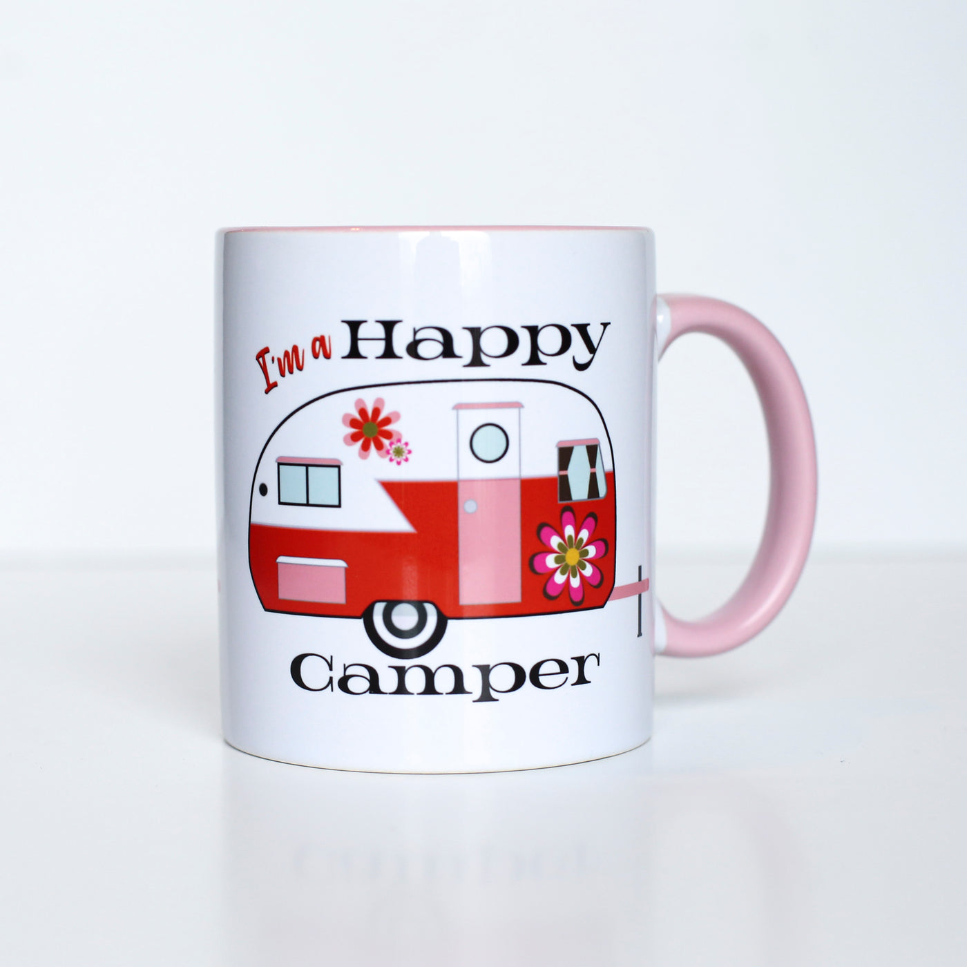 This 60's inspired Happy Camper with groovy flowers coffee mug gives you something special to wake up to besides the coffee! This vibrant mug features inside/handle color that will enhance the most creative of designs. Perfect for summer gifts, the Glamper Girl, or just to feel love on the bright side!  Ceramic mug with contrasting orange inside and handle coloring 11 oz mug Dishwasher and microwave safe
