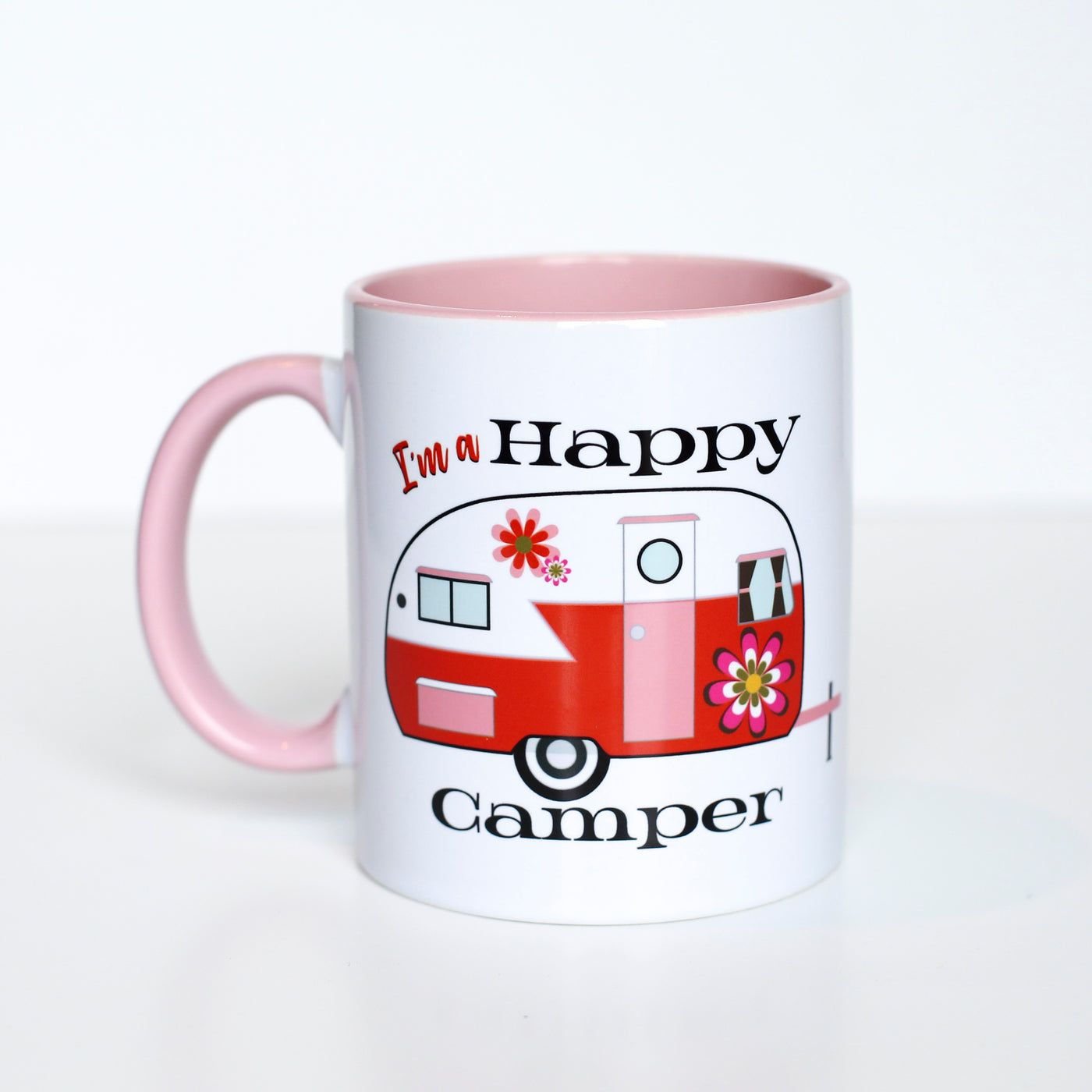 This 60's inspired Happy Camper with groovy flowers coffee mug gives you something special to wake up to besides the coffee! This vibrant mug features inside/handle color that will enhance the most creative of designs. Perfect for summer gifts, the Glamper Girl, or just to feel love on the bright side!  Ceramic mug with contrasting orange inside and handle coloring 11 oz mug Dishwasher and microwave safe